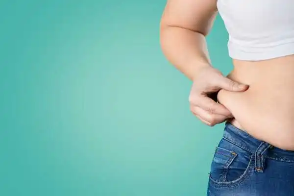 Image of woman pinching her love handles to show weight gain Hungerford